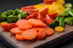 Salad of fresh and steamed vegetables cherry tomatoes, broccoli and carrots photo