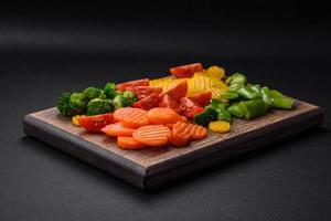 Salad of fresh and steamed vegetables cherry tomatoes, broccoli and carrots photo