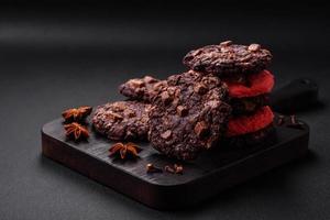 Delicious fresh crispy oatmeal cookies with chocolate and nuts photo