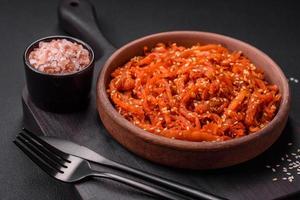 Dried squid chopped into slices and seasoned with sesame seeds and spices photo