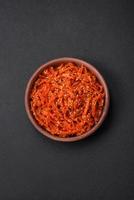 Dried squid chopped into slices and seasoned with sesame seeds and spices photo