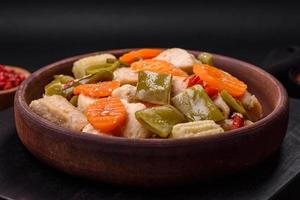 Delicious chicken slices and steamed vegetables carrots, broccoli, asparagus beans photo