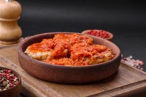 Delicious fresh cutlets or meatballs with spices, herbs and tomato sauce photo