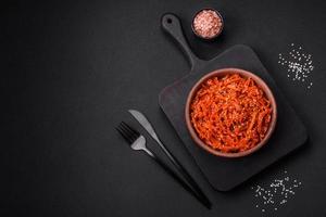Dried squid chopped into slices and seasoned with sesame seeds and spices photo