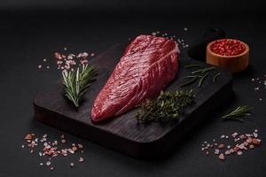 Beautiful fresh piece of raw beef on a wooden cutting board photo