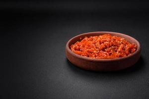 Dried squid chopped into slices and seasoned with sesame seeds and spices photo