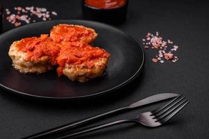 Delicious fresh cutlets or meatballs with spices, herbs and tomato sauce photo