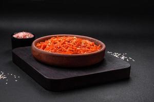 Dried squid chopped into slices and seasoned with sesame seeds and spices photo