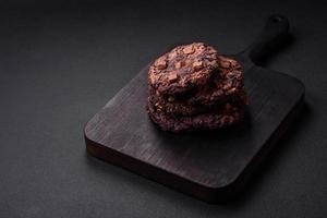 Delicious fresh crispy oatmeal cookies with chocolate and nuts photo