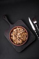 Fried or stewed champignon mushrooms in the form of slices with onions photo