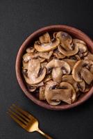 Fried or stewed champignon mushrooms in the form of slices with onions photo