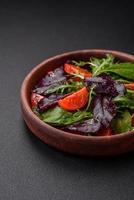 Salad of fresh cherry tomatoes, arugula, spinach and young beet leaves photo