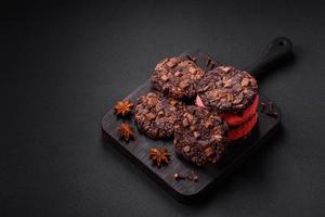 Delicious fresh crispy oatmeal cookies with chocolate and nuts photo