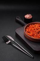Dried squid chopped into slices and seasoned with sesame seeds and spices photo