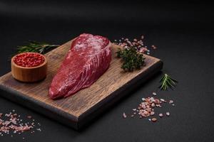 Beautiful fresh piece of raw beef on a wooden cutting board photo