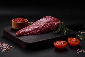 Beautiful fresh piece of raw beef on a wooden cutting board photo