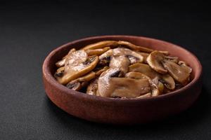 Fried or stewed champignon mushrooms in the form of slices with onions photo