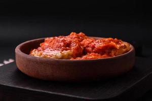 Delicious fresh cutlets or meatballs with spices, herbs and tomato sauce photo