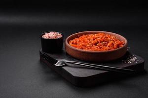 Dried squid chopped into slices and seasoned with sesame seeds and spices photo