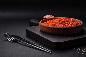 Dried squid chopped into slices and seasoned with sesame seeds and spices photo