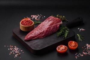 Beautiful fresh piece of raw beef on a wooden cutting board photo
