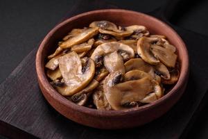 Fried or stewed champignon mushrooms in the form of slices with onions photo