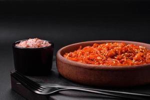 Dried squid chopped into slices and seasoned with sesame seeds and spices photo