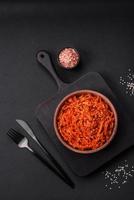 Dried squid chopped into slices and seasoned with sesame seeds and spices photo