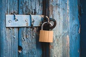 old door locked with new padlock photo