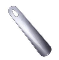 Gray plastic spatula for dressing shoes on a white isolated background, top view photo