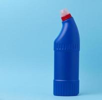 Blue plastic bottle for chemical detergents on a blue background photo