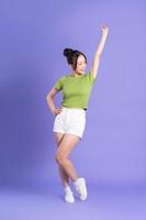 full body image of beautiful asian girl posing on pink background photo