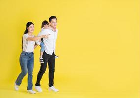 happy asian family image, isolated on yellow background photo