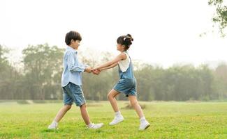 image of brother and sister having fun in the park photo