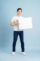 portrait of asian man posing on blue background photo