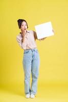 image of a pretty asian girl holding a white billboard photo