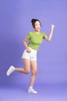 full body image of beautiful asian girl posing on pink background photo