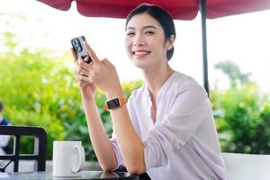 Portrait of beautiful asian woman sitting at cafe photo