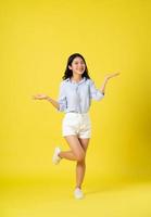 full body image of beautiful asian girl, isolated on yellow background photo