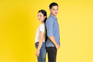 image of asian couple posing on yellow background photo