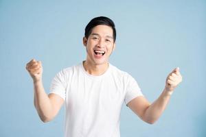 Asian male portrait posing on blue background photo