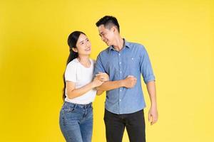 image of asian couple posing on yellow background photo