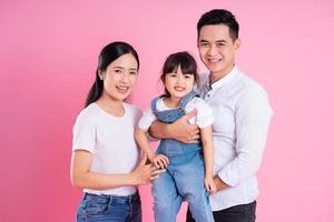 young asian family image isolated on pink background photo