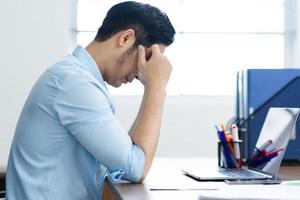 Asian businessman male portrait sitting at his desk photo