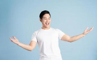 Asian male portrait posing on blue background photo