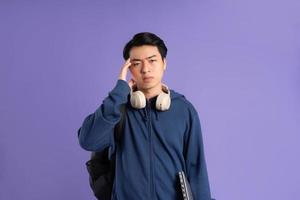 Asian male student portrait on purple background photo