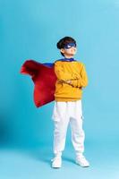 The image of a boy wearing a cape transforms into a hero photo