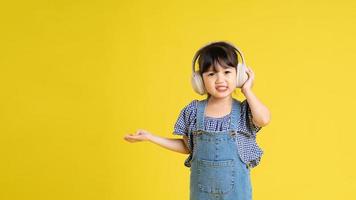 beautiful asian girl portrait, isolated on yellow background photo