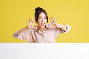 image of asian girl standing and posing with billboard photo