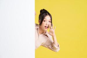 image of asian girl standing and posing with billboard photo